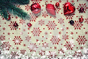 Red Christmas ornaments and xmas tree on canvas background with red glitter snowflakes. Xmas card. Happy New
