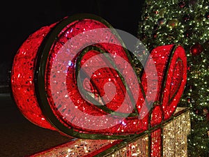 Red Christmas Present Bow and Tree at Night