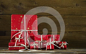 Red christmas presents on an old wooden brown background.