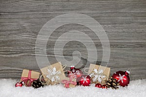 Red Christmas presents wrapped in natural paper on old wooden gr