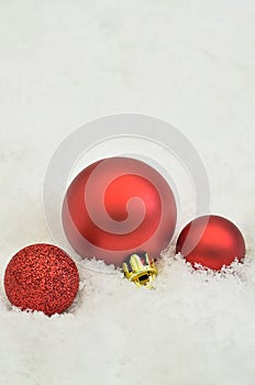 Red Christmas tree balls on Snow background