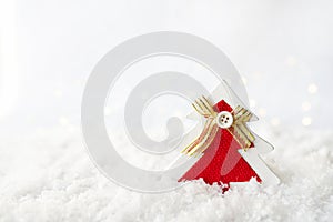 Red christmas tree decor staying on the snow, copy space