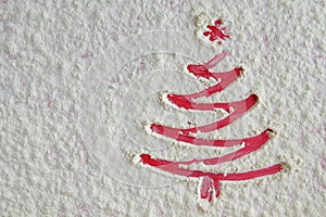 Red Christmas tree on flour background. White flour like snow