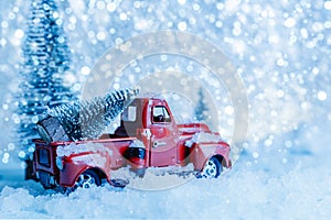 Red Christmas truck with pine tree on snow. Merry Christmas and happy new year concept