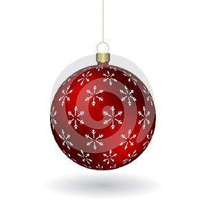 Red Christmass ball with snowflakes print hanging on a golden chain photo