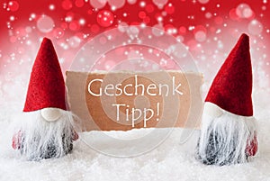 Red Christmassy Gnomes With Card, Geschenk Tipp Means Gift Tip photo