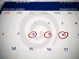 Red circle marked on three days calendar for reminder or remember important appointment