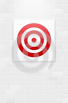 Red circle target hanging on brick wall