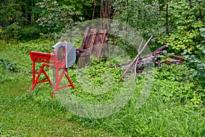 Red circular saw for firewood standing outdoors