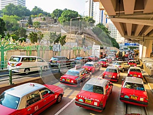 Red city taxis in road traffic, Hong Kong