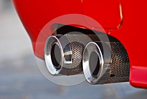 Red classic sport car exhaust close up