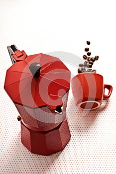 Red classical moka coffee maker pot with red cup and coffee cafe beans