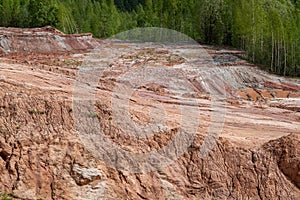 Red clay quarry. Clay quarry. Earth rocks are digging for building materials. Beautiful natural landscape to the land