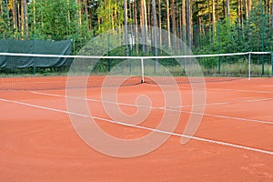 Red clay tennis court ready for individual workouts