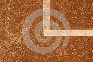 Red clay tennis court. White lines on a clay tennis court.