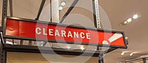 Red clearance sale sign in retain store. Sale signs in a clothing store