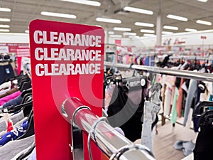 Red clearance sales sign at department store