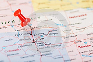 Red clerical needle on a map of United States, Wyoming and the capital Cheyenne. Close up map of wyoming with red tack, US map pin