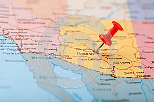 Red clerical needle on a map of the USA, Arizona and the capital Phoenix. Close up map of orizona with red tack