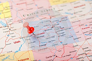 Red clerical needle on a map of USA, Colorado and the capital Denver. Closeup Map Colorado with Red Tack, United States map pin