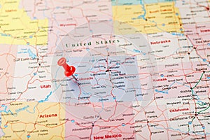 Red clerical needle on a map of USA, Colorado and the capital Denver. Closeup Map Colorado with Red Tack, United States map pin