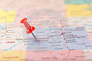 Red clerical needle on a map of USA, Colorado and the capital Denver. Closeup Map Colorado with Red Tack, United States map pin