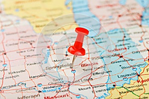 Red clerical needle on a map of USA, Illinois and the capital Springfield. Close up map of Illinois with red tack