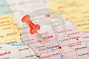 Red clerical needle on a map of USA, Iowa and the capital Des Moines. Close up map of Iowa with red tack