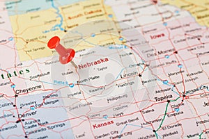 Red clerical needle on a map of USA, Nebraska and the capital Lincoln. Close up map of Nebraska with red tack