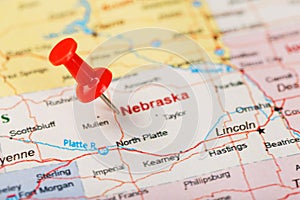 Red clerical needle on a map of USA, Nebraska and the capital Lincoln. Close up map of Nebraska with red tack