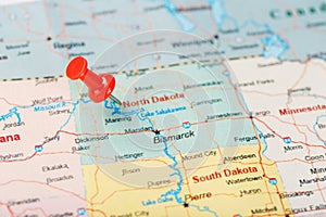 Red clerical needle on a map of USA, North Dakota and the capital Bismarck. Closeup Map North Dakota with Red Tack. United States