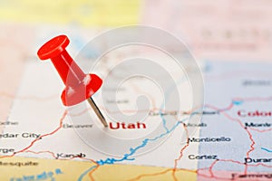 Red clerical needle on a map of USA, Utah and the capital Salt Lake City. Closeup Map Utah with Red Tack