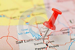 Red clerical needle on a map of USA, Utah and the capital Salt Lake City. Closeup Map Utah with Red Tack
