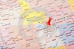 Red clerical needle on a map of USA, Utah and the capital Salt Lake City. Closeup Map Utah with Red Tack