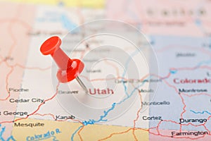 Red clerical needle on a map of USA, Utah and the capital Salt Lake City. Closeup Map Utah with Red Tack