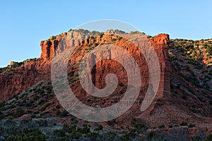 Red cliff at Caprock Canyon Texas lit by sunset