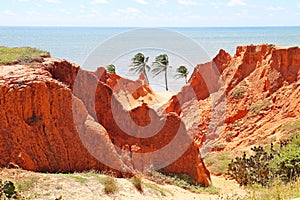 Red cliffs near the sea at Morro Branco, Ceara, Brasil. Beauty of erosion made by rain and wind.