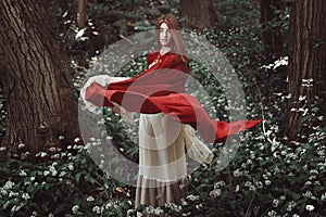 Red cloaked girl in a fantasy forest