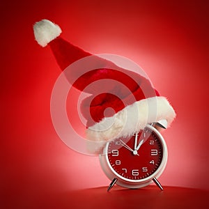 Red clock with Christmas Santa hat. Time for Christmas shopping.
