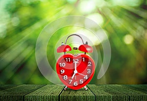 Red clock mark on 7 o`clock put on wooden tabletop