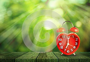 Red clock mark on 7 o`clock put on wooden tabletop