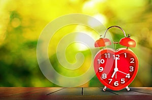 Red clock mark on 7 o`clock put on wooden tabletop