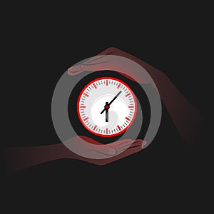 Red clock and person`s hands near it in darkness