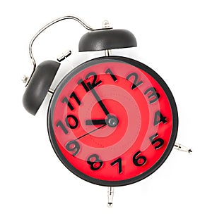 Red clock pointing at 10 on white .