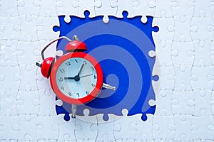 Red clock with white puzzle