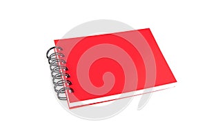 Red closed paper notepad with ring binder isolated on white back