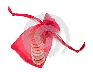 Red cloth bag with coin inside