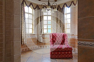 Red cloth sofa in castle tower old building interior