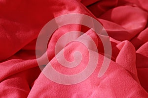 Red cloth table napkins clumped up and wrinkled