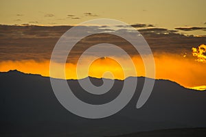 Red clouds of fire with the rays of a sunrise photo